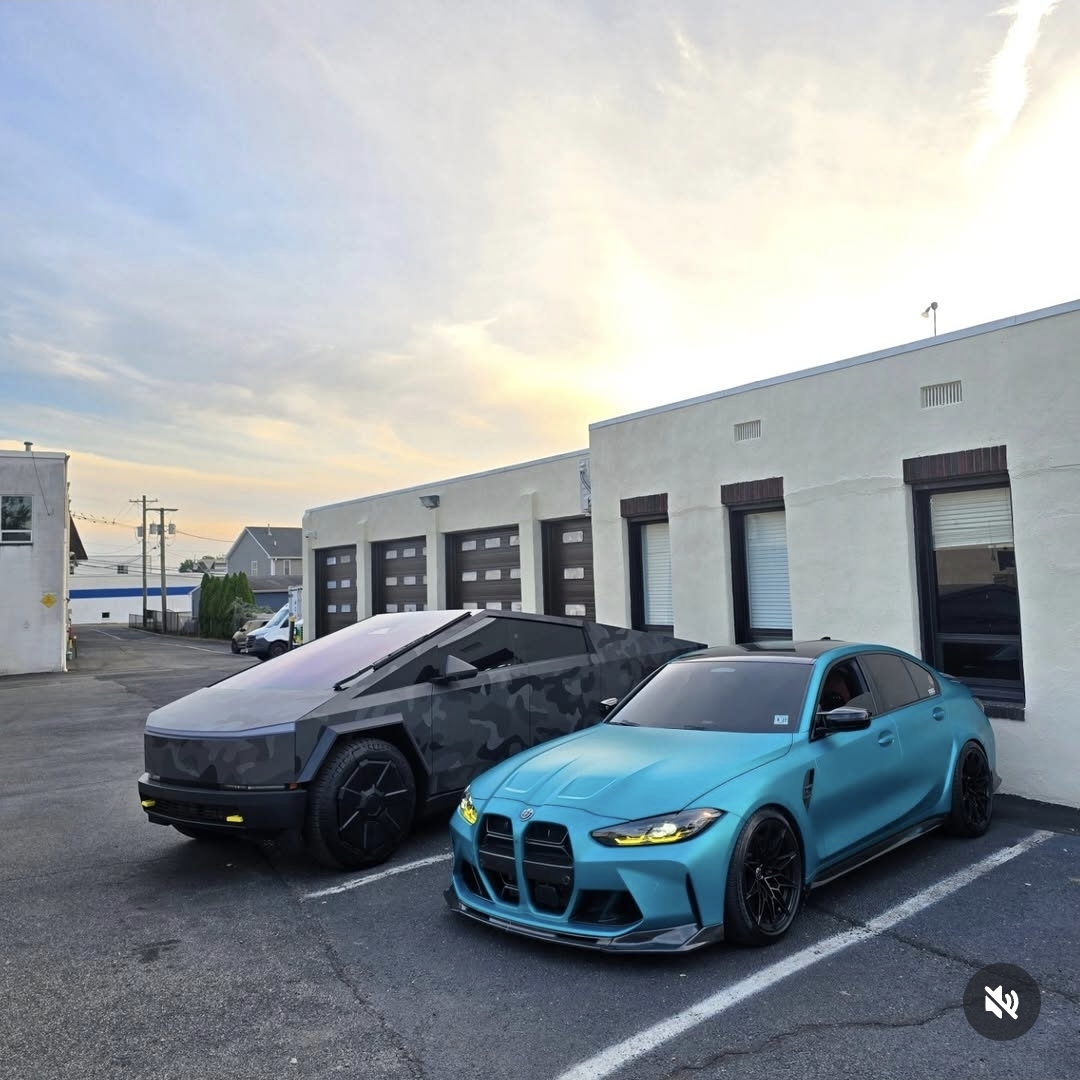 Camouflage wrapped Tesla Cybertruck next to a teal BMW M3
