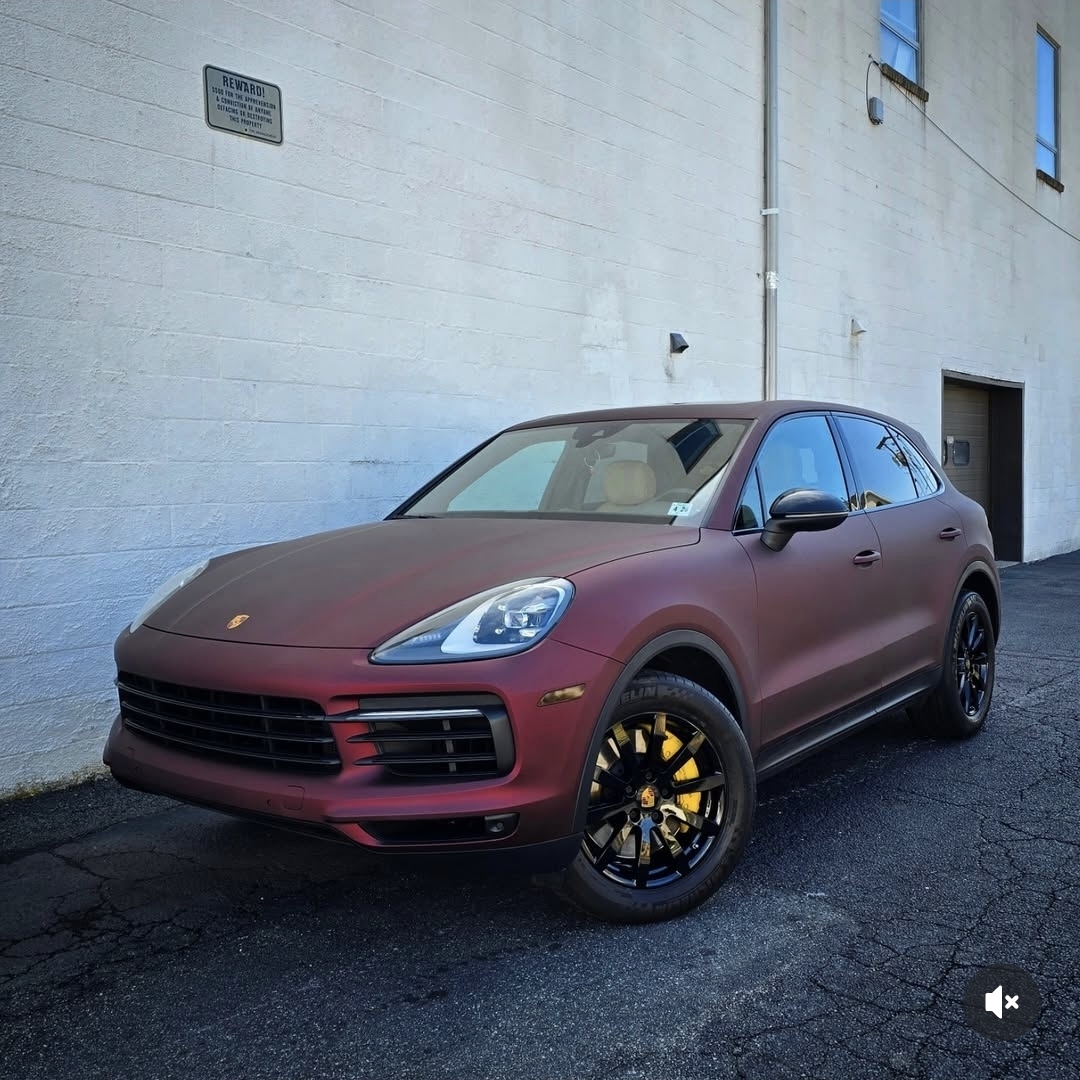 Matte maroon Porsche Cayenne SUV with yellow brake calipers wrapped in KPMF vinyl